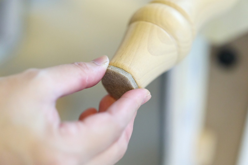 furniture-pad-being-installed-on-chair-leg Furniture pad being installed on a chair leg.